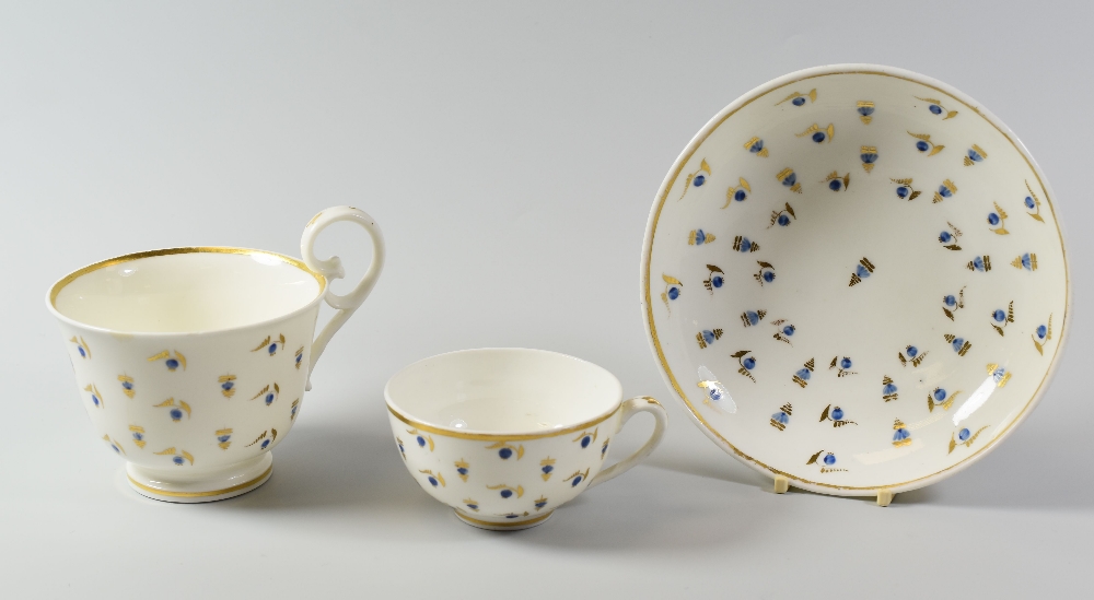 A NANTGARW PORCELAIN HENSOL CASTLE PATTERN BREAKFAST CUP TRIO the larger cup with slightly flared