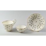 A NANTGARW PORCELAIN HENSOL CASTLE PATTERN BREAKFAST CUP TRIO the larger cup with slightly flared