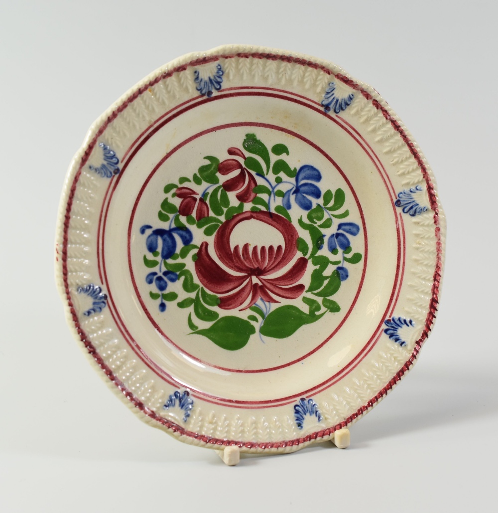 A SWANSEA POTTERY CHILD'S PLATE, Baker, Bevans & Irwin period, the border with continuous moulded