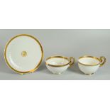 A SWANSEA PORCELAIN PARIS FLUTE TRIO circa 1815, undecorated but for gilded trim and gilded centre