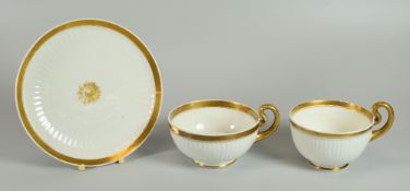 A SWANSEA PORCELAIN PARIS FLUTE TRIO circa 1815, undecorated but for gilded trim and gilded centre