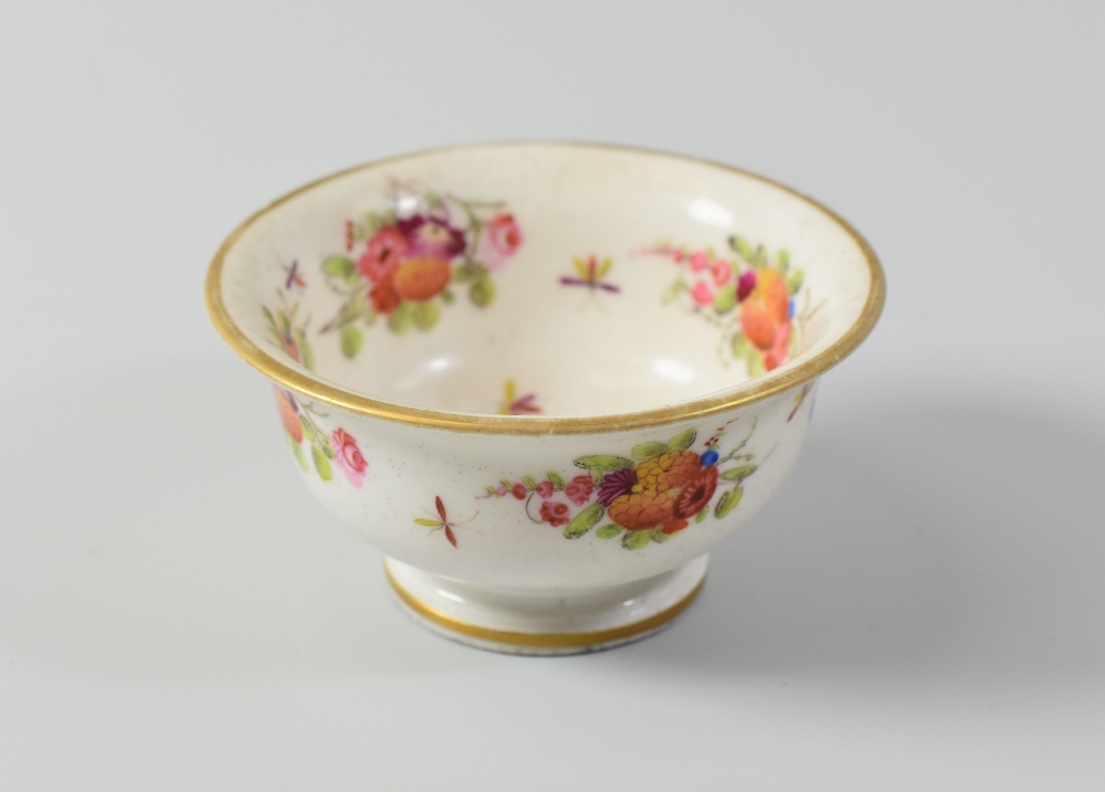 A SWANSEA PORCELAIN TEA-BOWL with flared rim and flanged foot, painted with floral sprays and