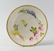 A SWANSEA PORCELAIN PLATE decorated with individual floral specimens including bluebells and roses