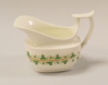 A SWANSEA PORCELAIN CREAM JUG having a wide elongated spout with spurred and shouldered loop handle,