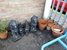 A pair of stoneware lions together with a pair of gnomes and a parcel of sundry pots