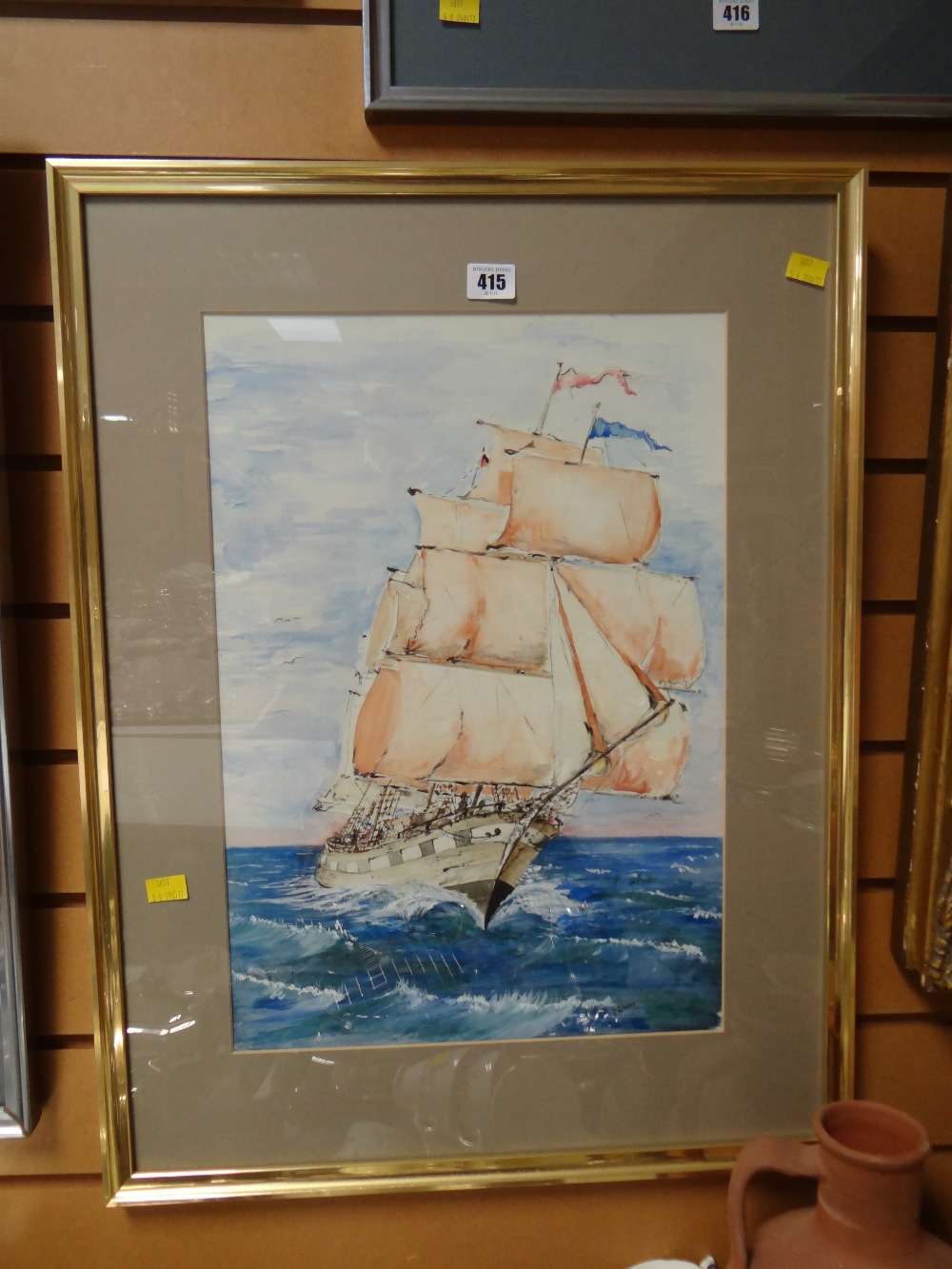 A framed watercolour of a galleon at sea by D J Thomas
