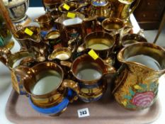A tray of copper lustre jugs