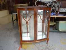 A polished two-door glazed china cabinet