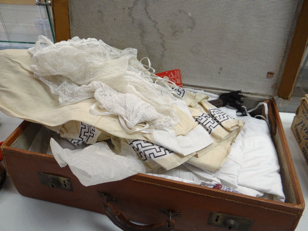 A vintage suitcase and a quantity of good vintage linen