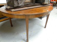 An antique mahogany extending dining table