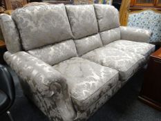An almost new Parker Knoll three-seater settee in silver floral fabric of classical design (cost