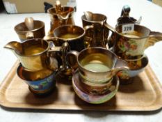 Eight copper lustre jugs
