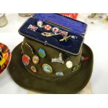 An Alpine ramblers vintage hat with tourist badges, a cased collection of badges etc