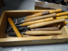 A box of wooden handled carpentry chisels