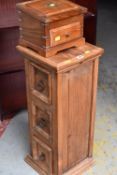 A lightwood planter stand with drawers and a hardwood box