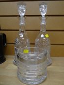 Two cut glass decanters and a glass ice bucket