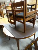 Nathan-Suite circular extending dining table and four chairs