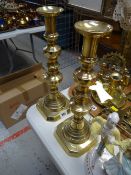 A pair of good tall brass candlestick holders