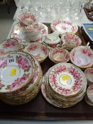 An excellent vintage rose decorated extensive tea set, unmarked with gilded serial number to the