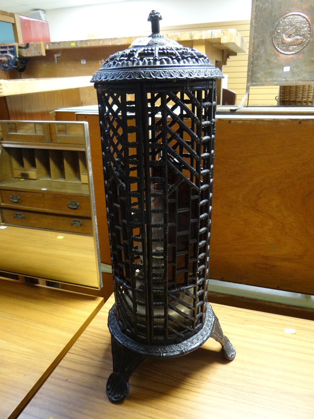 A black cast iron floor standing oil lantern