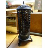 A black cast iron floor standing oil lantern