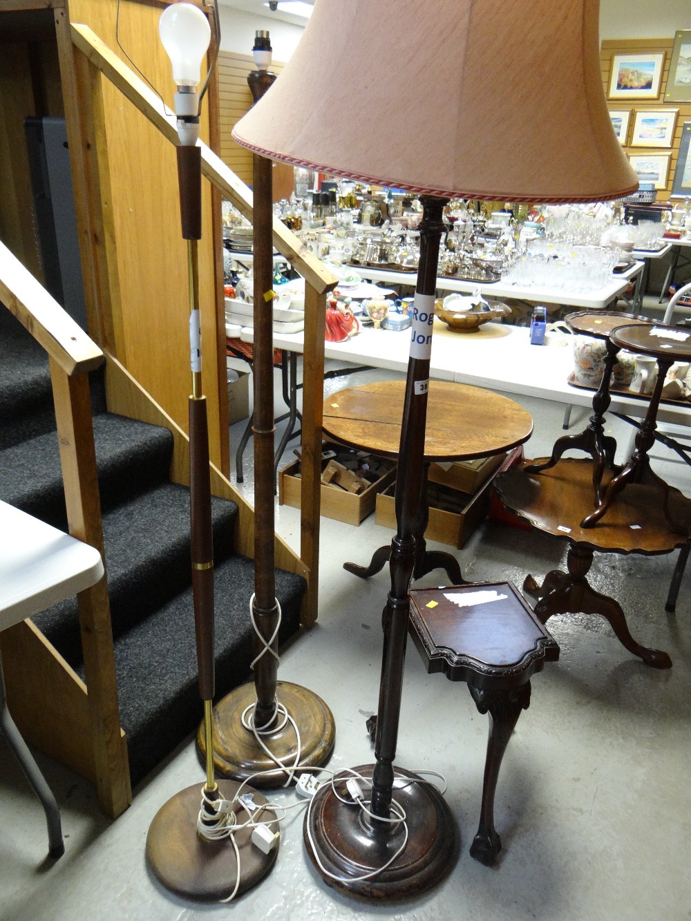 Three sundry standard lamps and a three footed mahogany antique stand