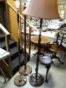 Three sundry standard lamps and a three footed mahogany antique stand