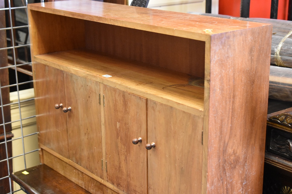 A lightwood four-door cupboard / bookcase