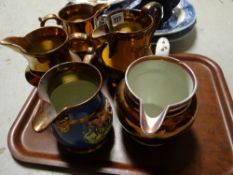 Five copper lustre jugs