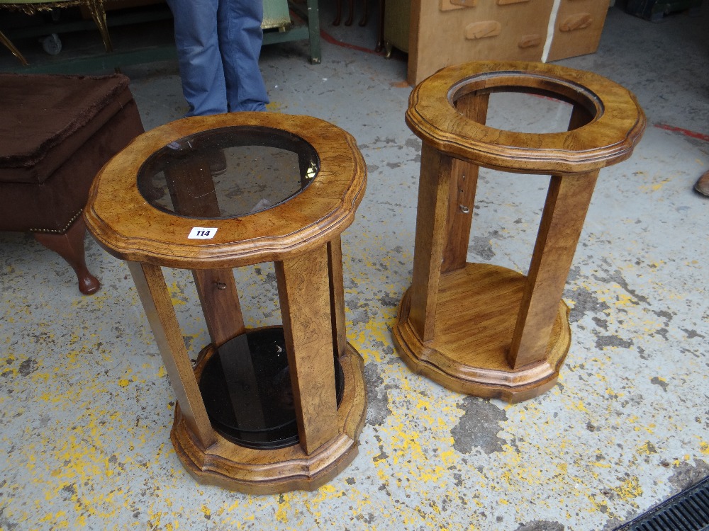 A pair of walnut-effect shelved and glass topped pedastals