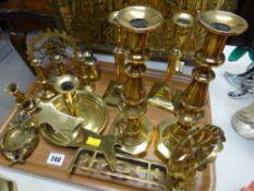 A parcel of brass ware including antique candlestick holders