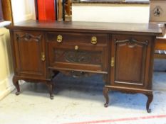 Large vintage mahogany sideboard on raised feet with carved drawer and pull down front, flanked by