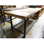 A lightwood top workbench on metal supports