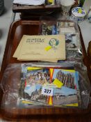 A quantity of old postcards and albums of cigarette cards