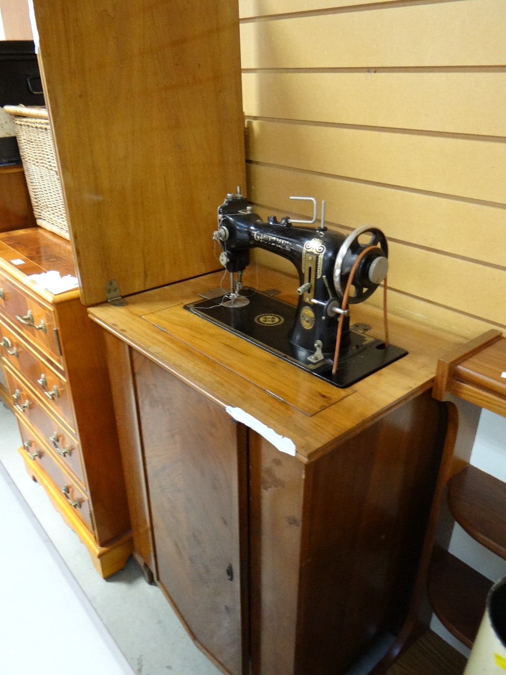 A vintage walnut cased electric sewing machine