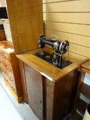 A vintage walnut cased electric sewing machine