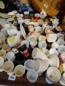 A large collection of novelty egg cups