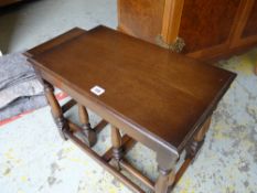 A nest of three dark wood coffee tables