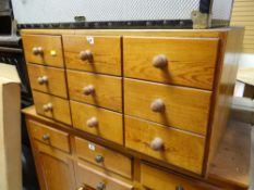 A good table top pine chest with bank of nine drawers