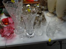 A parcel of glassware including cut glass vases, a pair of cranberry glass floral dishes, a pair