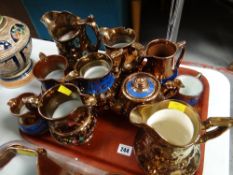 A tray of copper lustre jugs