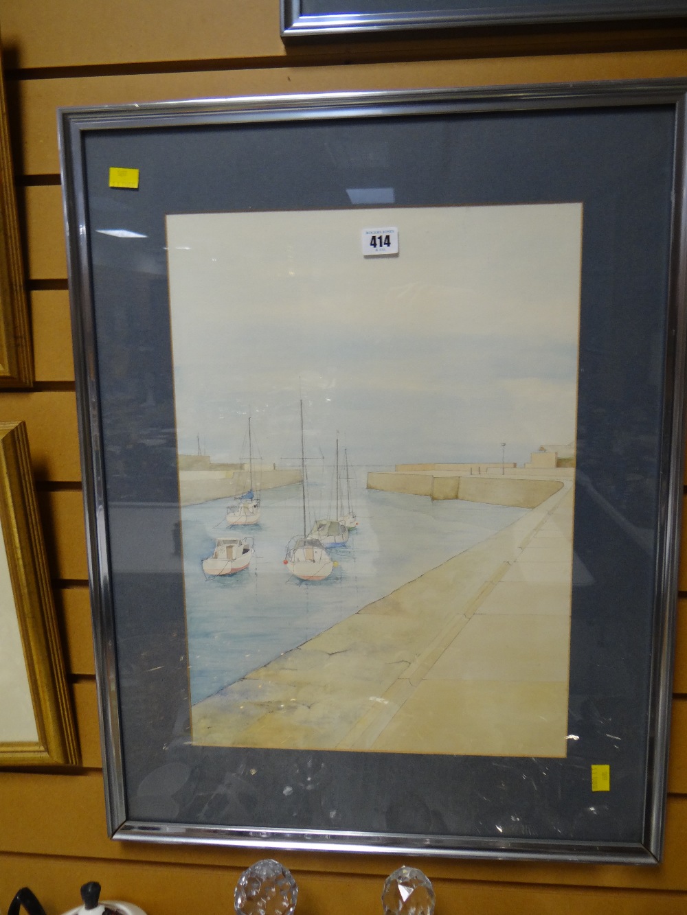 A framed watercolour of a harbour with boats in a minimalist style believe by D J Thomas