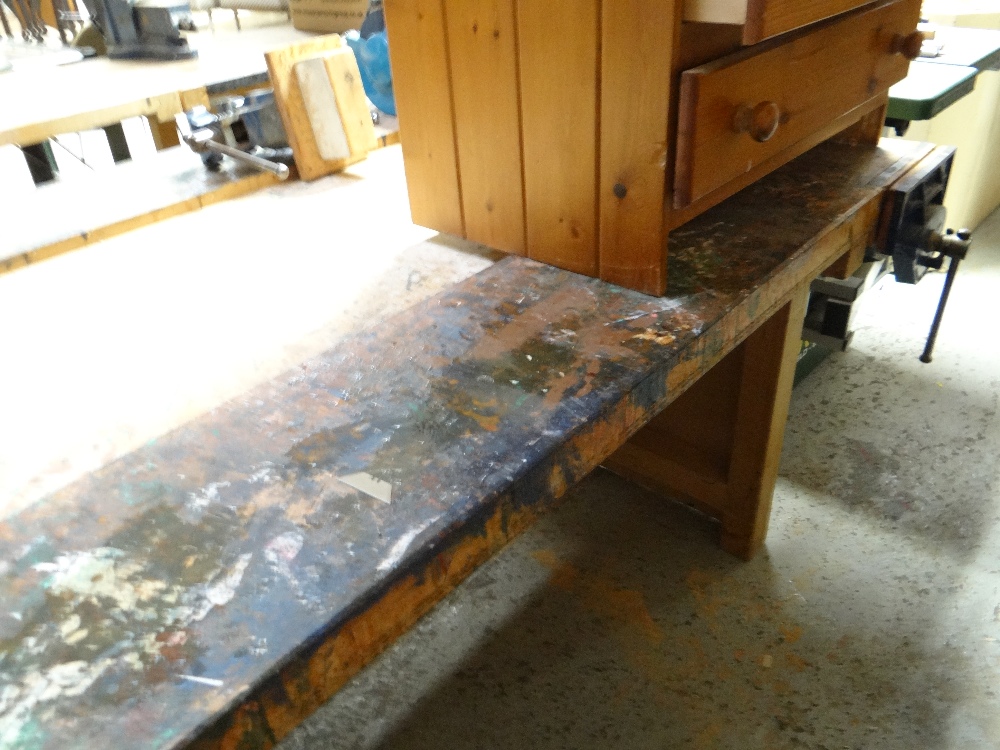 A large workshop workbench with vice together with a lightwood workshop table with drawers