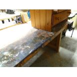 A large workshop workbench with vice together with a lightwood workshop table with drawers