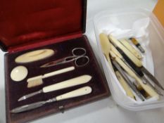 A parcel of bone handled hand tools including pen knife and button hook, a bone child's spoon etc