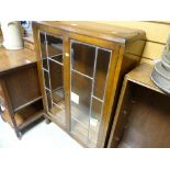 A vintage two-door glazed bookcase