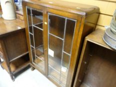 A vintage two-door glazed bookcase