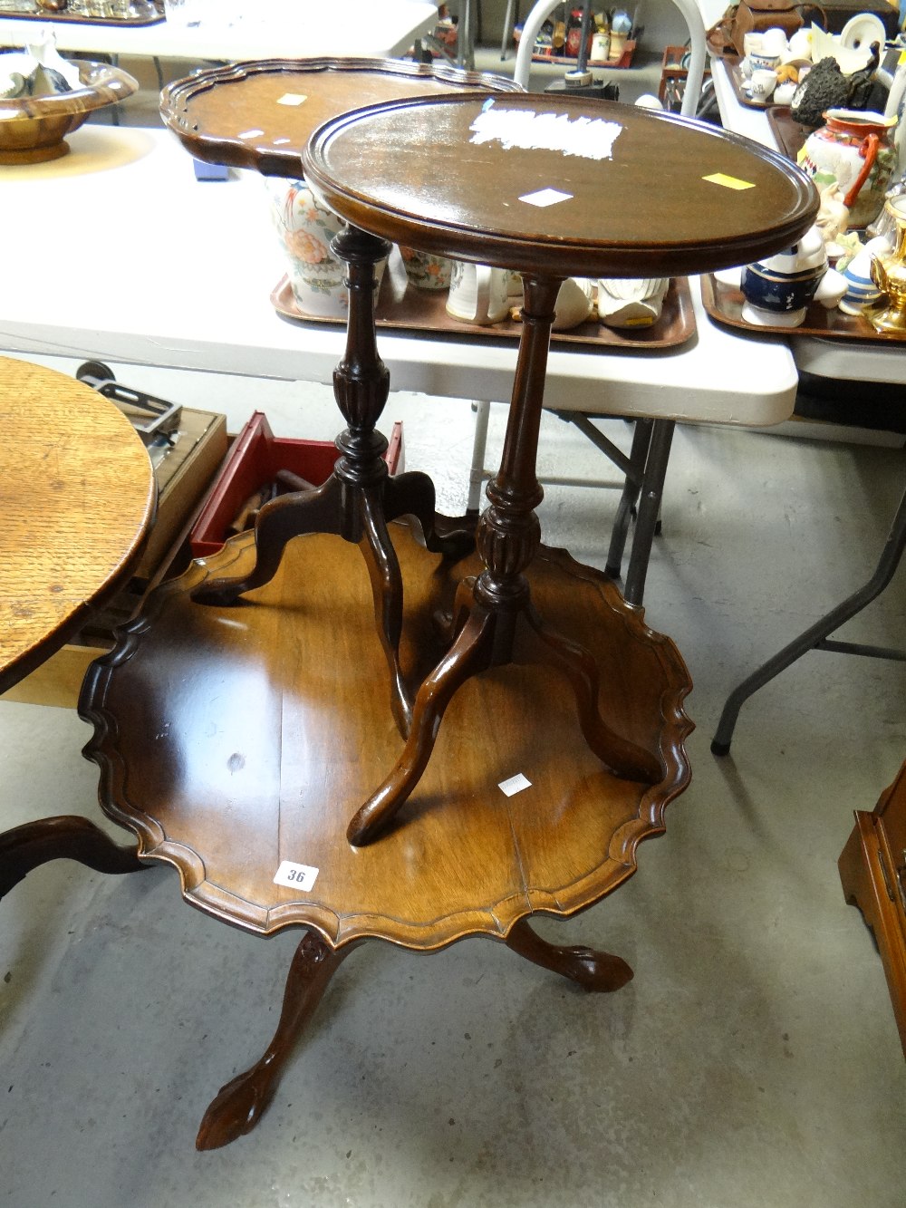 A reproduction mahogany circular pie crust side table together with two reproduction mahogany wine