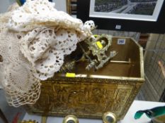 A brass and wood magazine rack, a brass bell and sundry lace items