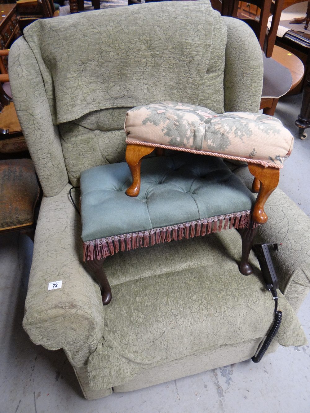 A modern electric rise and fall armchair and two foot stools